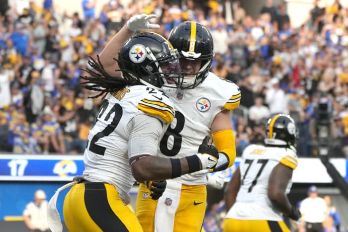 Kenny Pickett puts his hand on Najee Harris’s helmet as the two jump in celebration